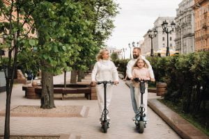 a family in white clothes rides electric scooters KGLN7W6 everyday nature Citygreen